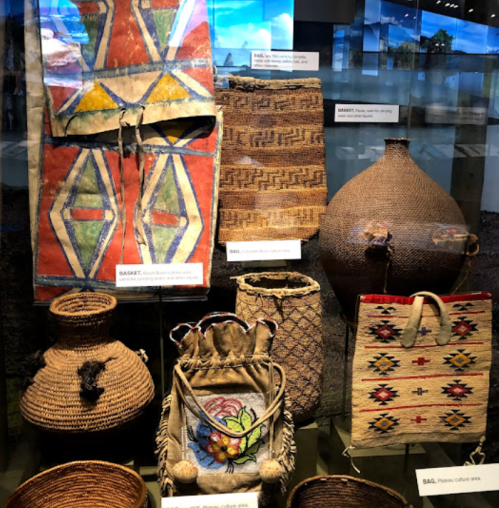 A display of various woven baskets and bags, showcasing intricate designs and textures.