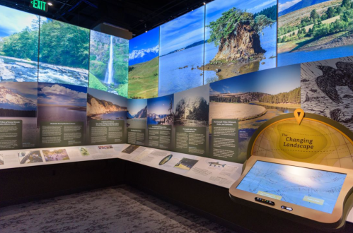 Exhibit showcasing landscapes with informative panels and a touchscreen display titled "The Changing Landscape."
