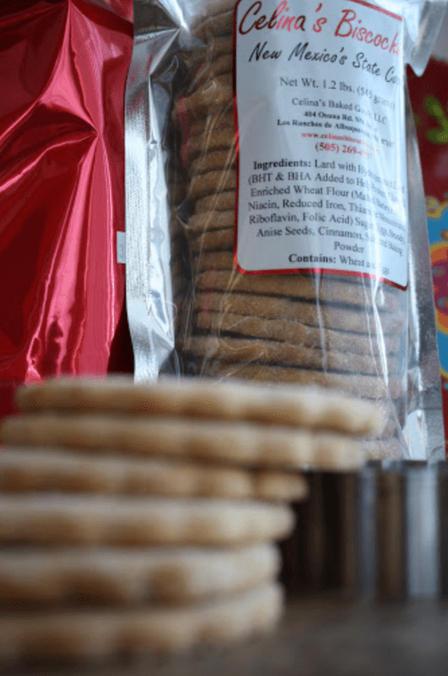 A package of Celina's biscochitos with stacked cookies in the foreground, showcasing ingredients and branding.