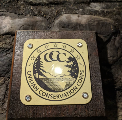 Logo of the Civilian Conservation Corps (CCC) featuring trees, water, and mountains, with dates 1933-1942.