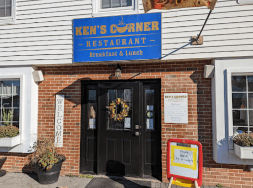 Exterior of Ken's Corner Restaurant, featuring a welcoming entrance and a sign for breakfast and lunch.