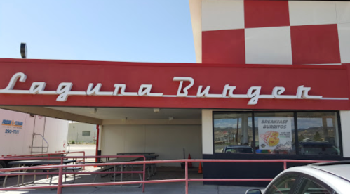 Sign for Lagura Burger with a red and white checkered design, featuring a menu for breakfast burritos.