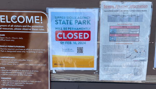 Sign announcing Upper Sioux Agency State Park will be permanently closed on February 16, 2024, with severe weather info.