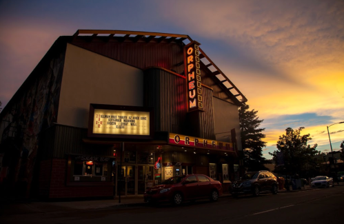 The Orpheum Theater at dusk, featuring a marquee and vibrant sunset colors in the background.
