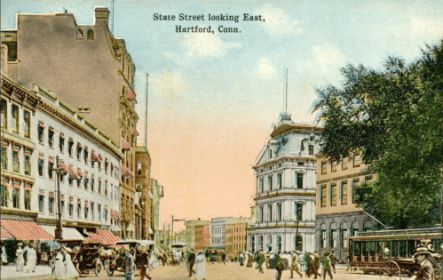 Historic view of State Street in Hartford, Connecticut, featuring buildings, streetcars, and pedestrians.