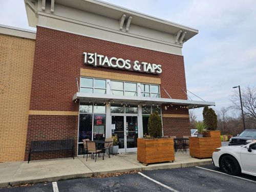 Exterior of 131 Tacos & Taps restaurant, featuring a welcoming entrance and outdoor seating area.