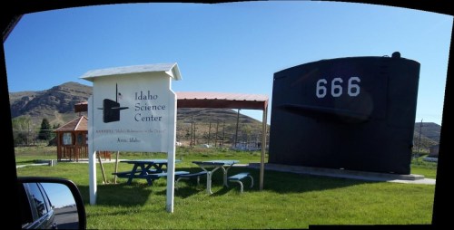 Sign for Idaho Science Center with a large submarine display nearby, set against a mountainous landscape.