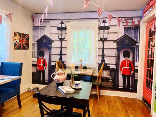 Cozy café interior with British-themed decor, including guards, a red phone booth, and Union Jack accents.