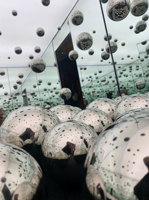A reflective surface with shiny spheres and mirrors, creating a mesmerizing, infinite space effect.