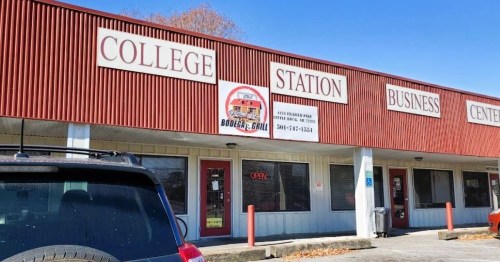 Exterior of a business center featuring "College Station" and "Boozer's Grill" signs, with a parked car in front.
