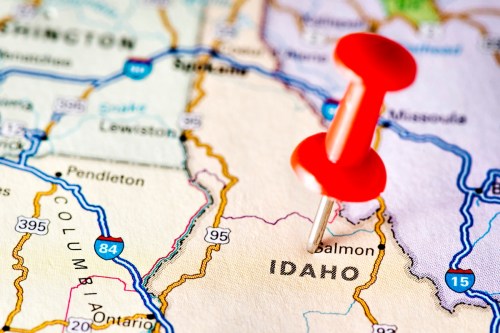 A close-up of a map of Idaho with a red pushpin marking a location.