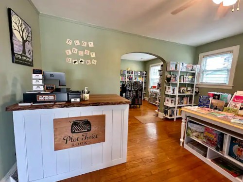 Cozy bookstore interior with a wooden counter, bookshelves, and a welcoming atmosphere.