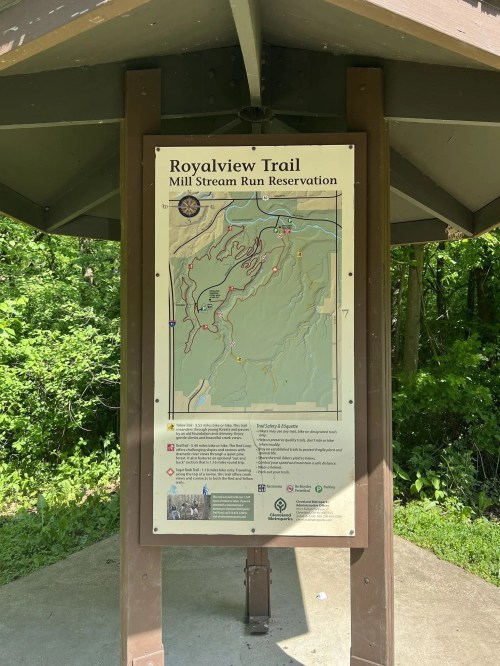 Map of Royalview Trail at Mill Stream Run Reservation, displayed on a sign under a shelter in a wooded area.