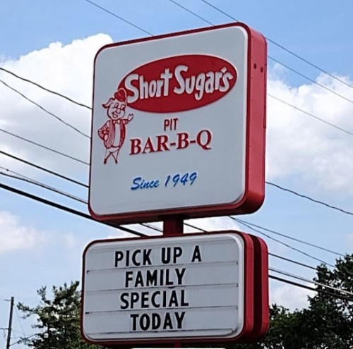 Sign for Short Sugars Pit Bar-B-Q, advertising a family special available today. Established in 1949.