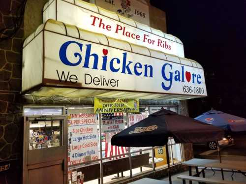 Sign for "Chicken Galore" restaurant featuring delivery options and a banner for their 50th anniversary celebration.