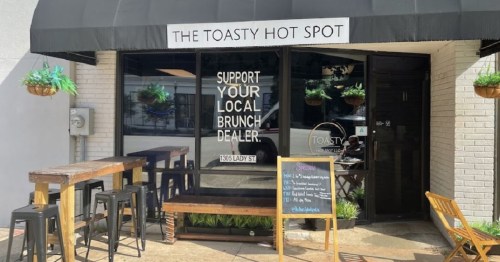 Exterior of The Toasty Hot Spot café with a sign promoting local brunch and outdoor seating.