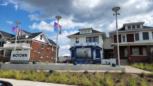 Exterior view of the Motown Museum, featuring the "Hitsville U.S.A." sign and surrounding buildings under a cloudy sky.