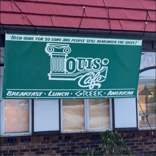 Green sign for Louis Café, featuring "Breakfast, Lunch, Greek, American" and a tagline about lasting taste.