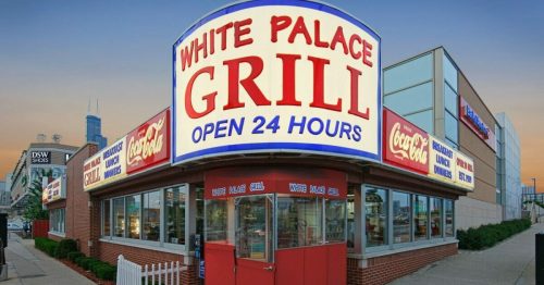 A brightly lit diner, White Palace Grill, with a large sign stating "Open 24 Hours" and Coca-Cola branding.