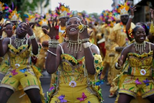 A vibrant parade scene with dancers in colorful costumes, celebrating with joy and energy.