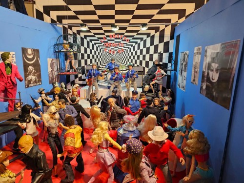A vibrant display of action figures and dolls in a colorful, checkered room, creating a lively scene.