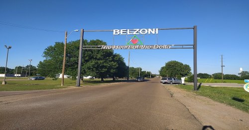 Sign welcoming visitors to Belzoni, Mississippi, with the tagline "The Heart of the Delta," on a clear day.