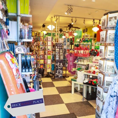 A colorful gift shop filled with various items, including cards, souvenirs, and decorations, with a welcoming atmosphere.
