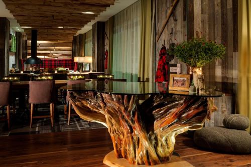 A stylish interior featuring a unique wooden table, elegant seating, and warm lighting in a cozy dining space.