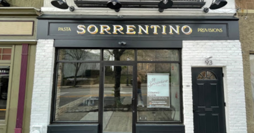 Exterior of a restaurant named "Pasta Sorrentino Provisions," featuring a black and white facade and a "Coming Soon" sign.