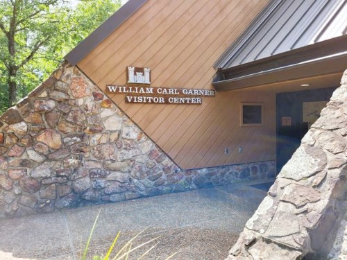 Exterior of the William Carl Garner Visitor Center, featuring a stone and wood facade.
