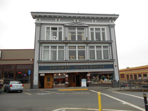Historic building with a sign for Jacoby's Storehouse, featuring a pizza grill and law offices on the upper floors.