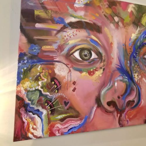 A colorful abstract painting of a face, featuring vibrant swirls and expressive eyes.