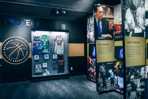 Exhibit showcasing basketball jerseys, memorabilia, and images celebrating the National Basketball Players Association.