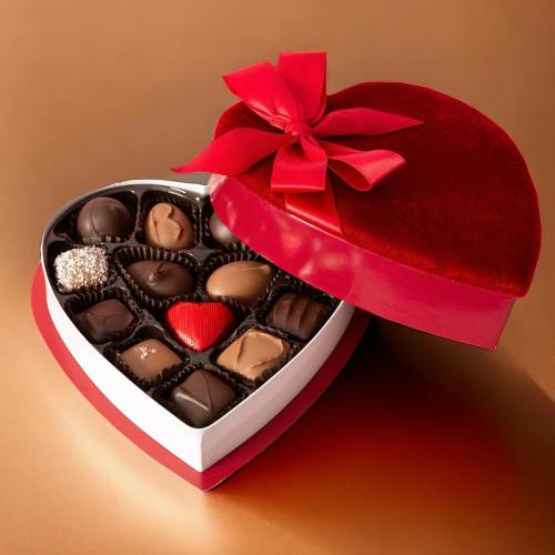 A heart-shaped box of assorted chocolates, featuring a red ribbon and twelve delicious treats inside.