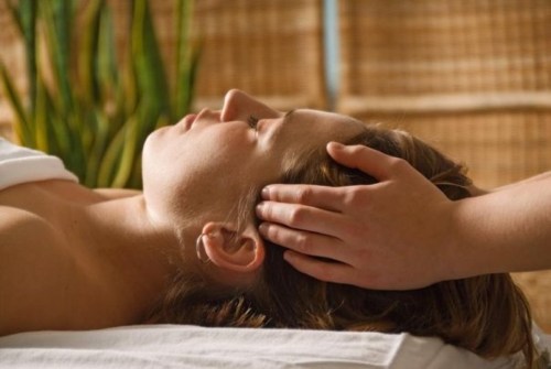 A person receiving a relaxing head massage in a serene spa setting.