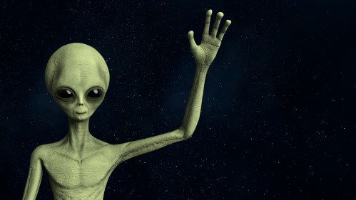 A green alien with large eyes waves against a starry space background.