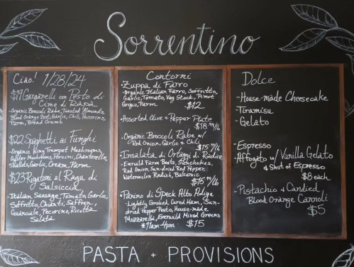Chalkboard menu for Sorrentino featuring pasta, sides, desserts, and drinks with prices listed.
