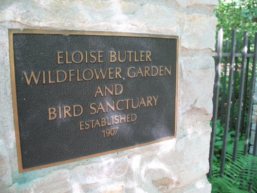 Plaque for Eloise Butler Wildflower Garden and Bird Sanctuary, established in 1907, mounted on a stone wall.