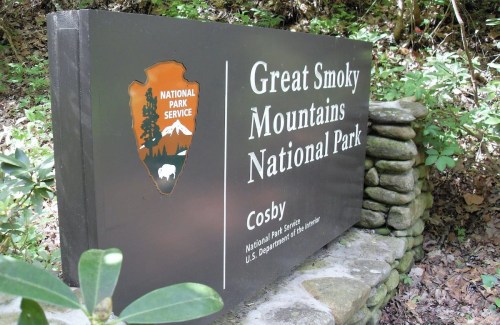 Sign for Great Smoky Mountains National Park in Cosby, featuring the National Park Service logo and stone border.