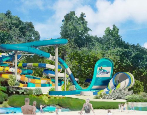 Colorful water slides at a water park, surrounded by greenery and people enjoying the sunny day.