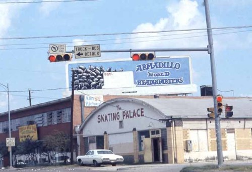 Traffic lights and a detour sign near a building labeled "Skating Palace," with a billboard for "Armadillo World Headquarters."