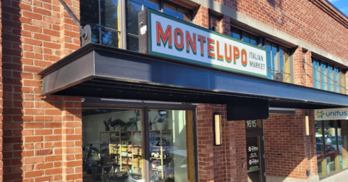 Exterior of Montelupo Italian Market, featuring a brick facade and a sign above the entrance.