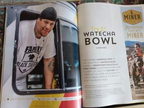 A man in a t-shirt stands by a food truck, promoting the Watecha Bowl in a magazine article.