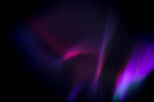 Abstract image featuring swirling colors of purple, pink, and blue against a dark background.
