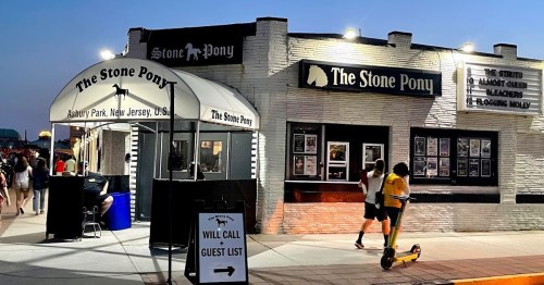 The Stone Pony venue in Asbury Park, New Jersey, with people walking by and a sign for will call and guest list.