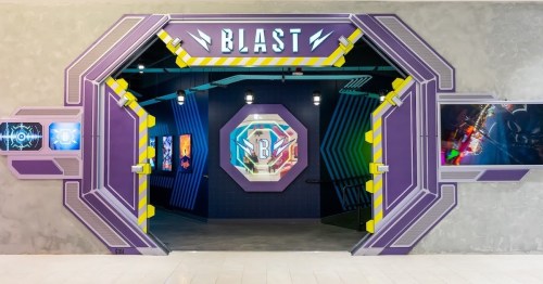 A colorful entrance to an arcade or gaming area, featuring the word "BLAST" and vibrant wall art.