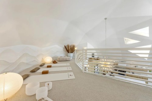 A serene, minimalist loft space with soft lighting, decorative elements, and a cozy atmosphere.