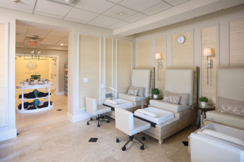 A serene spa interior featuring comfortable seating, pedicure stations, and a welcoming reception area.