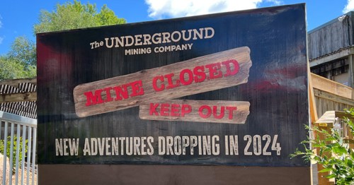 Sign reading "Mine Closed, Keep Out" with a note about new adventures coming in 2024.