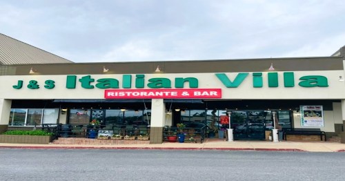 Exterior of J&S Italian Villa restaurant, featuring a large sign and outdoor seating area.